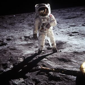 A picture of a apollo astronaut standing on the surface of the moon