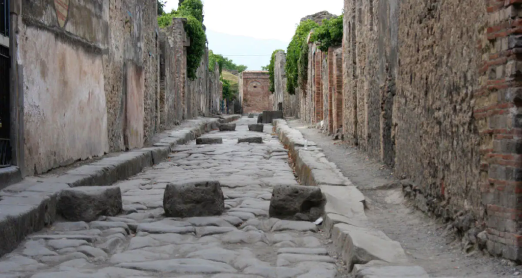 Stone street of Pompeii. High curbs with three stepping stones to cross the road on