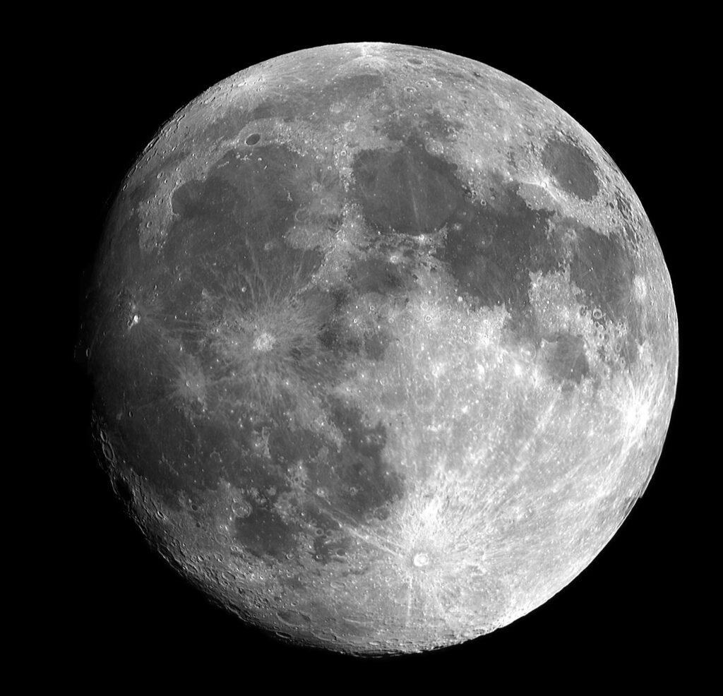 The moon with visible craters in the black night sky