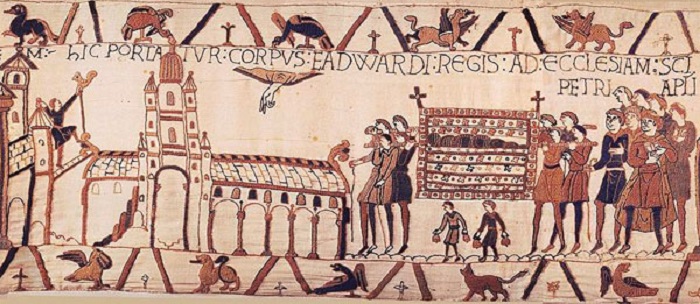 Section of the Bayeux Tapestry which shows the funeral of Edward the Confessor. Eight people carry a coffin towards the abbey on the left of the section. 